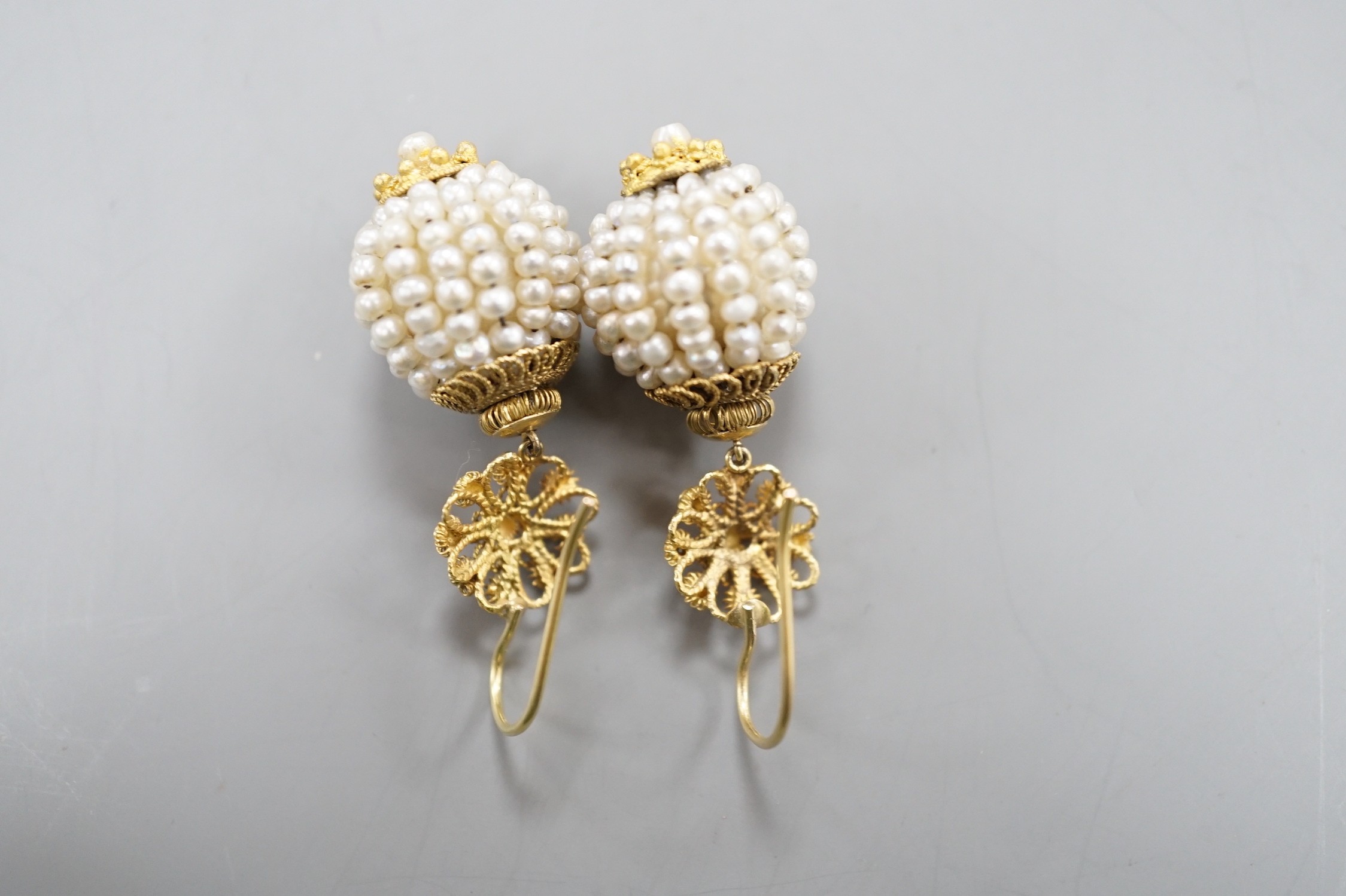 A pair of 19th century filigree yellow metal and multi seed pearl set spherical drop earrings, 34mm, gross weight 9.3 grams.